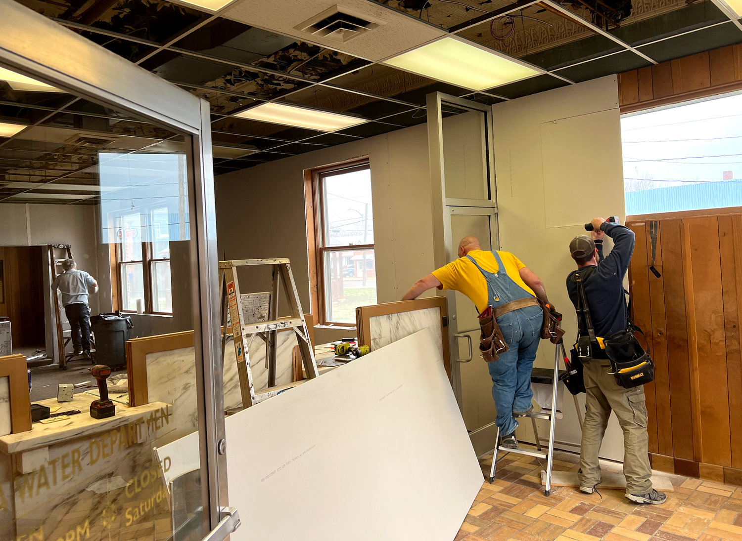 A construction crew works on the newly-hung drywall in the Democrat’s new building, 111 W. Fourth St., on Monday, March 21. The building formerly housed the Sedalia Water Department and was purchased by the Democrat in late 2021.